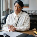 Confident businesswoman working at her desk in a modern office setting, focusing on an important task.